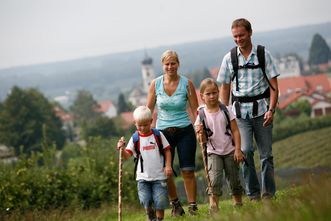 Wandernde Familie im Hopfengarten